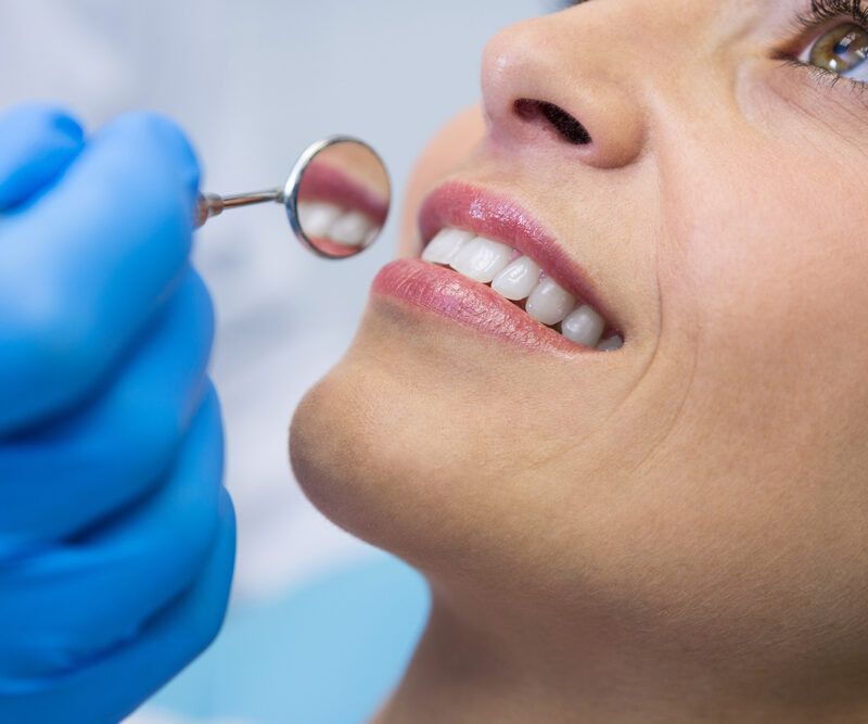 Woman smiling after dental cleaning in Auburn, CA